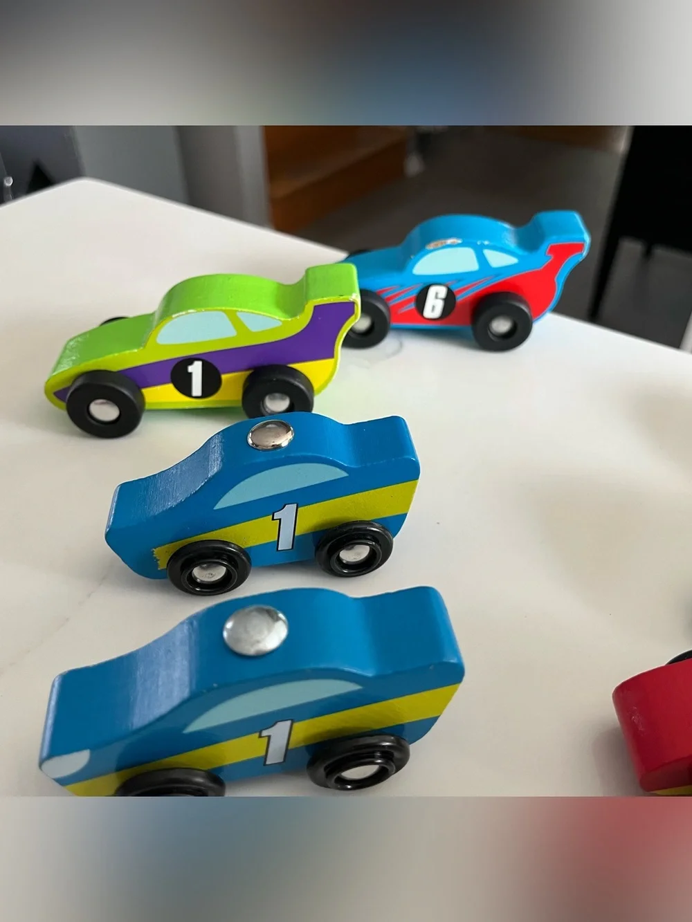 8 wooden racing cars.   Cars Number 1-4 are Melissa & Doug.